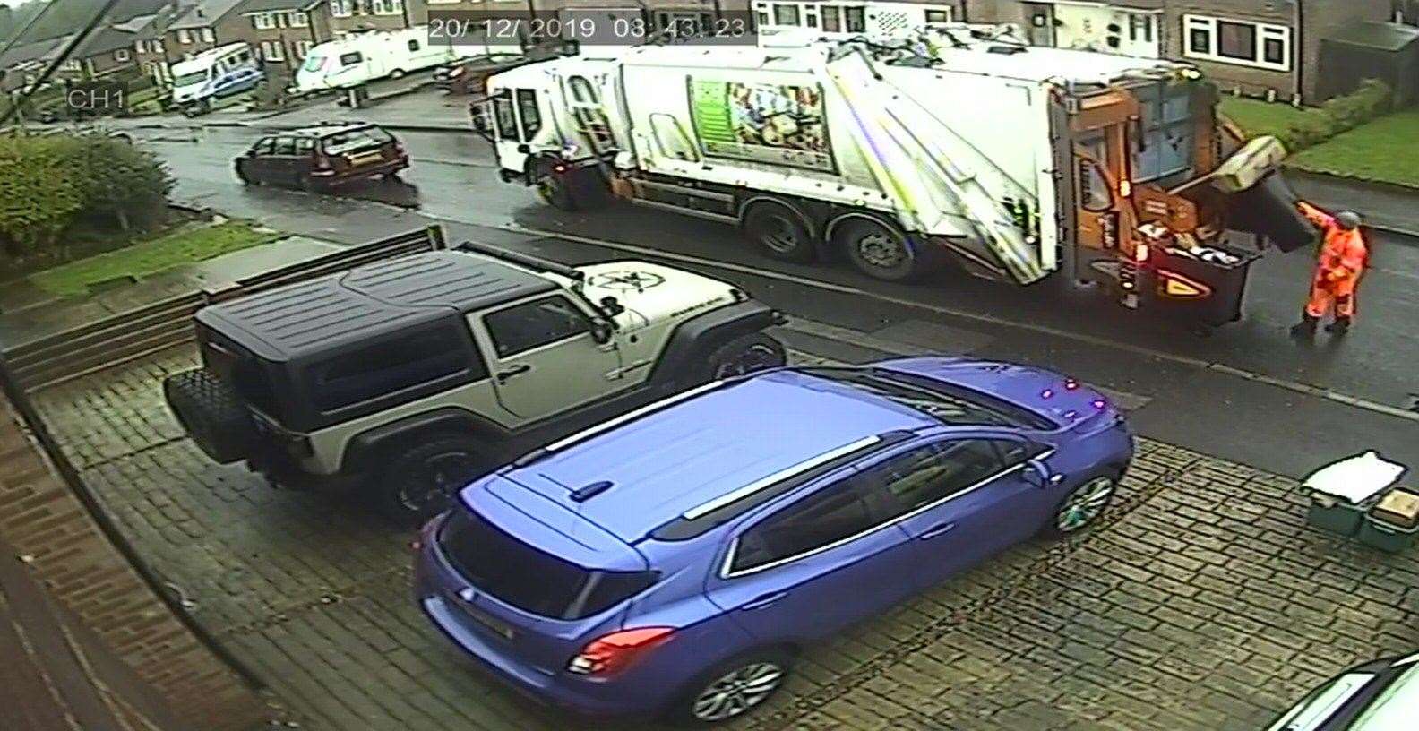 The binmen load cardboard into the same section of the refuse lorry as the other recycled waste