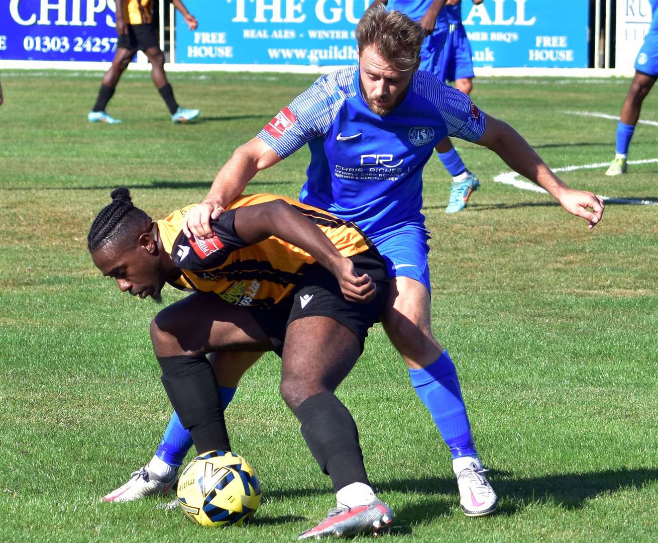 Ira Jackson under pressure for Folkestone against Herne Bay's Jack Parter. Picture: Randolph File