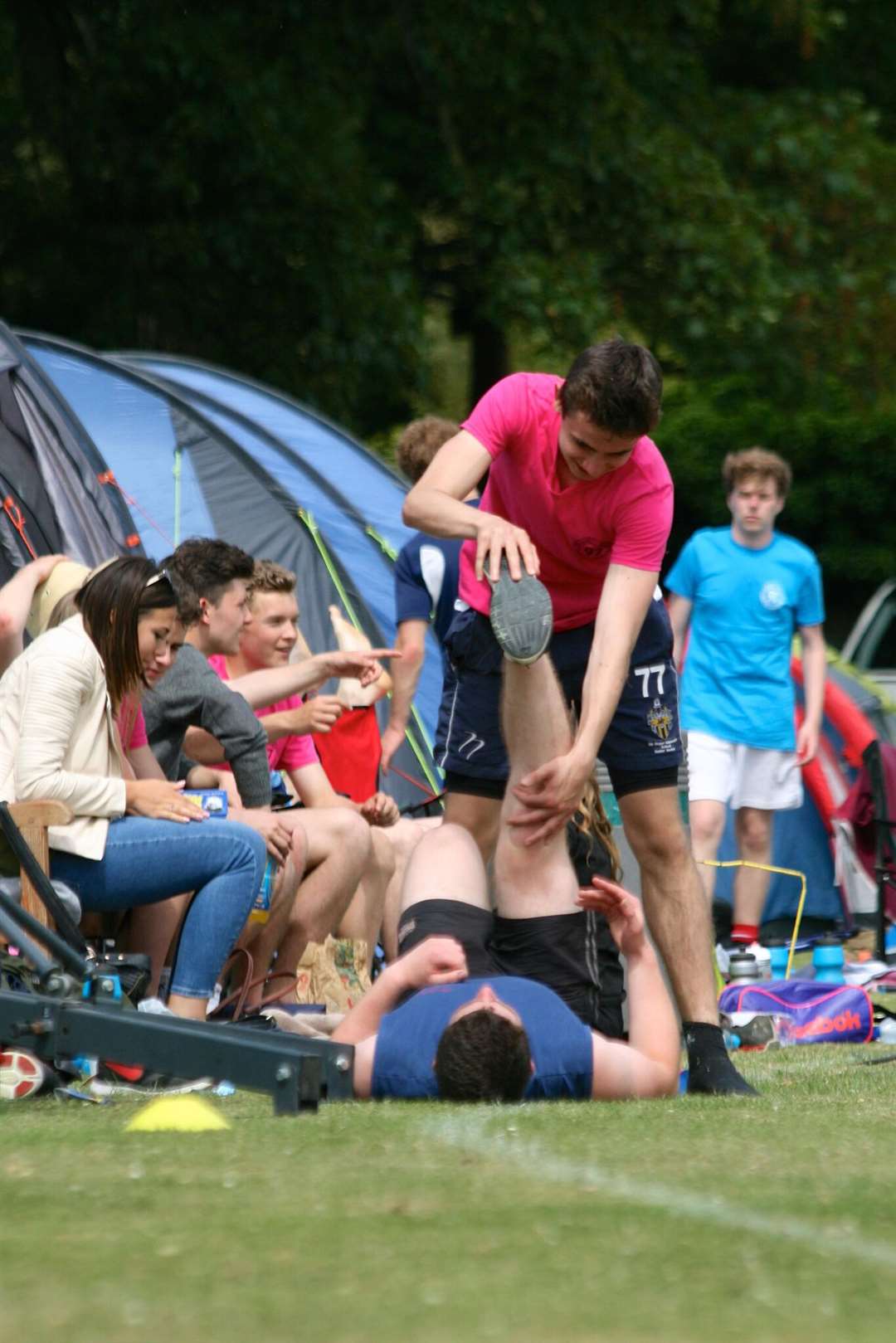 Manwood pupils help stretch out their muscles after playing rugby