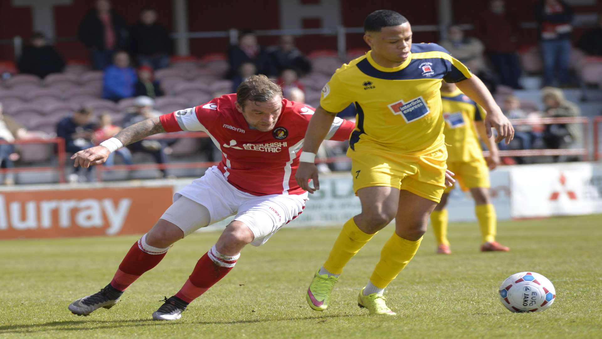 Danny Kedwell keeps a close eye on Eastbourne's Gavin McCallum Picture: Ruth Cuerden