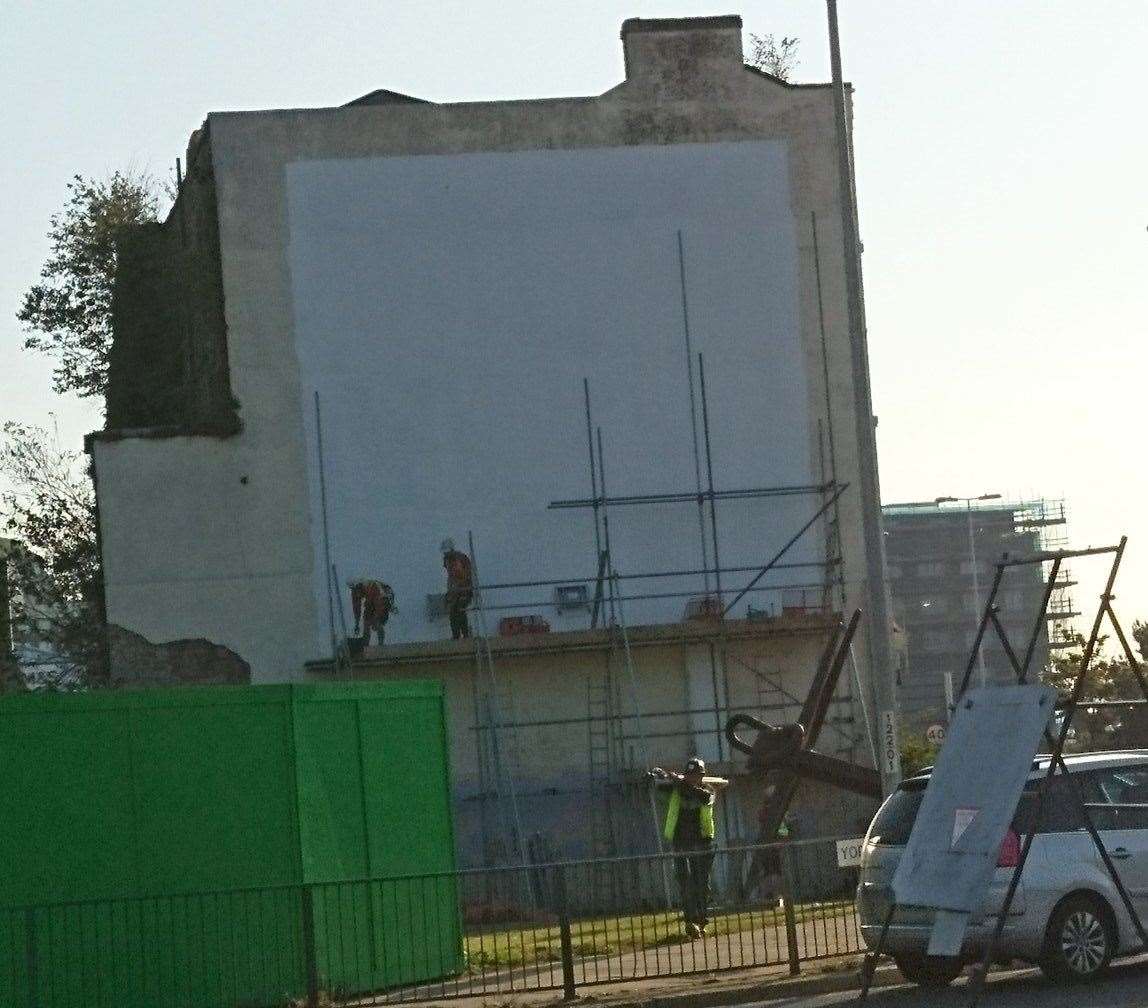 Workmen remove the scaffolding, as this tweet image just before 9am shows. Picture: @Hironius