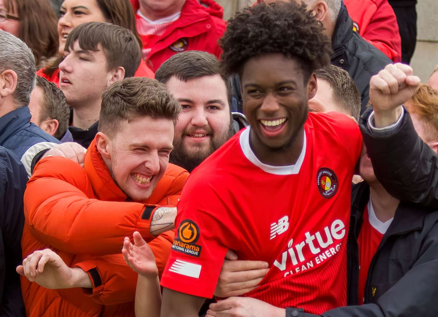 Bryant Bilongo celebrates Ebbsfleet's National League safety with the club's fans. Picture: Ed Miller/EUFC