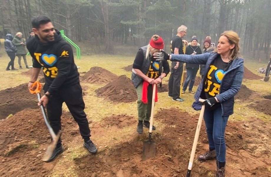 MP Natalie Elphicke and Amir Khan digging the playground at an orphanage in Poland