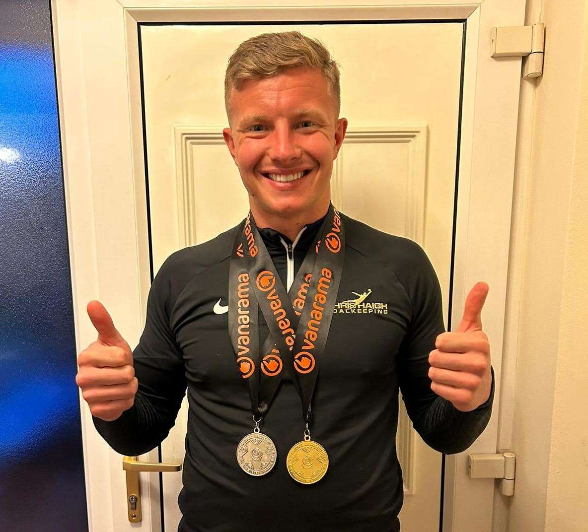 Ebbsfleet keeper Chris Haigh with his two medals - a National League South title and play-off winner in one season.