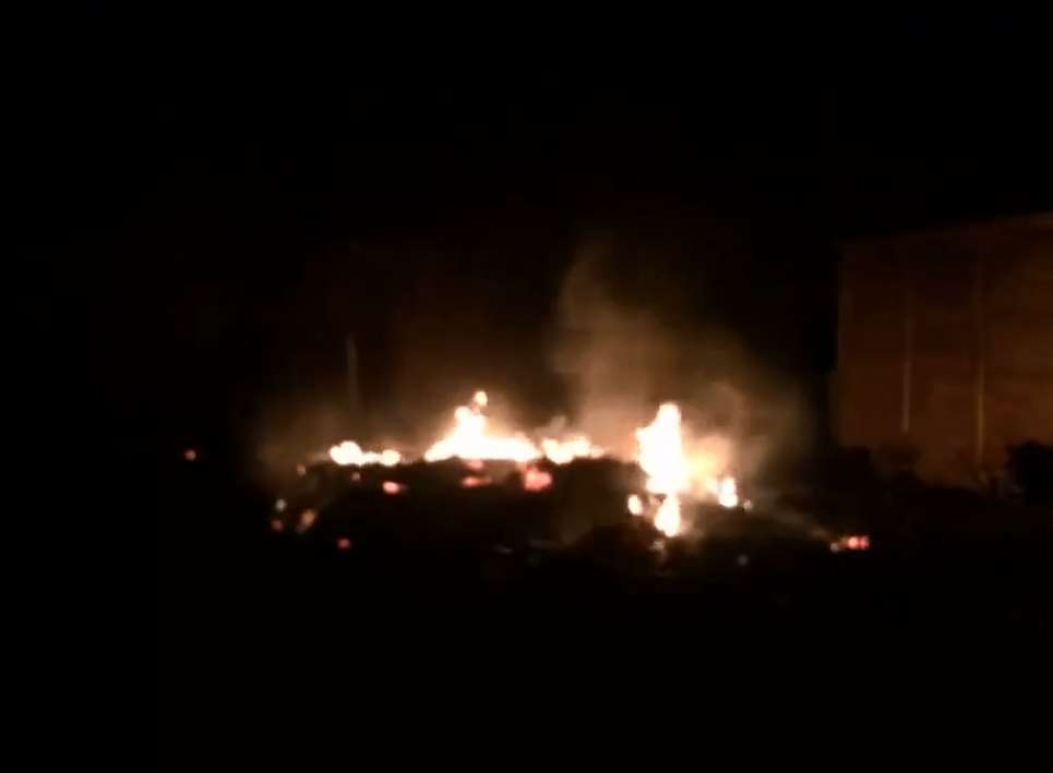 The burning ruins of the stable block