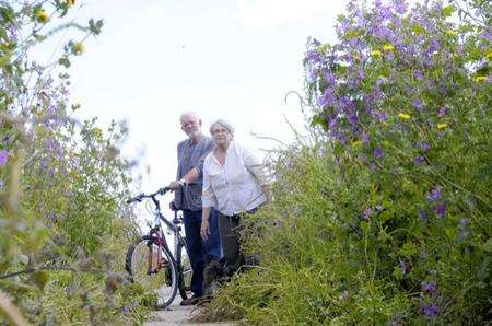 Lynne and Vic Clarke with their dog Baggins who have complained to the council about the cycle path near their home, which has become over-grown and virtually impassable