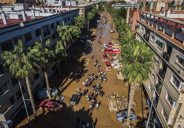 Volunteers and residents in Valencia clean the mud four days after flash floods. Picture: Angel Garcia/AP