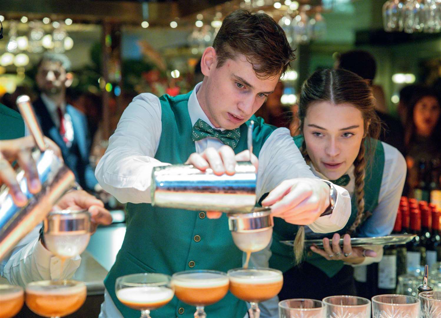 Bar staff hard at work perfecting espresso martini cocktails. Pic: The Ivy Canterbury