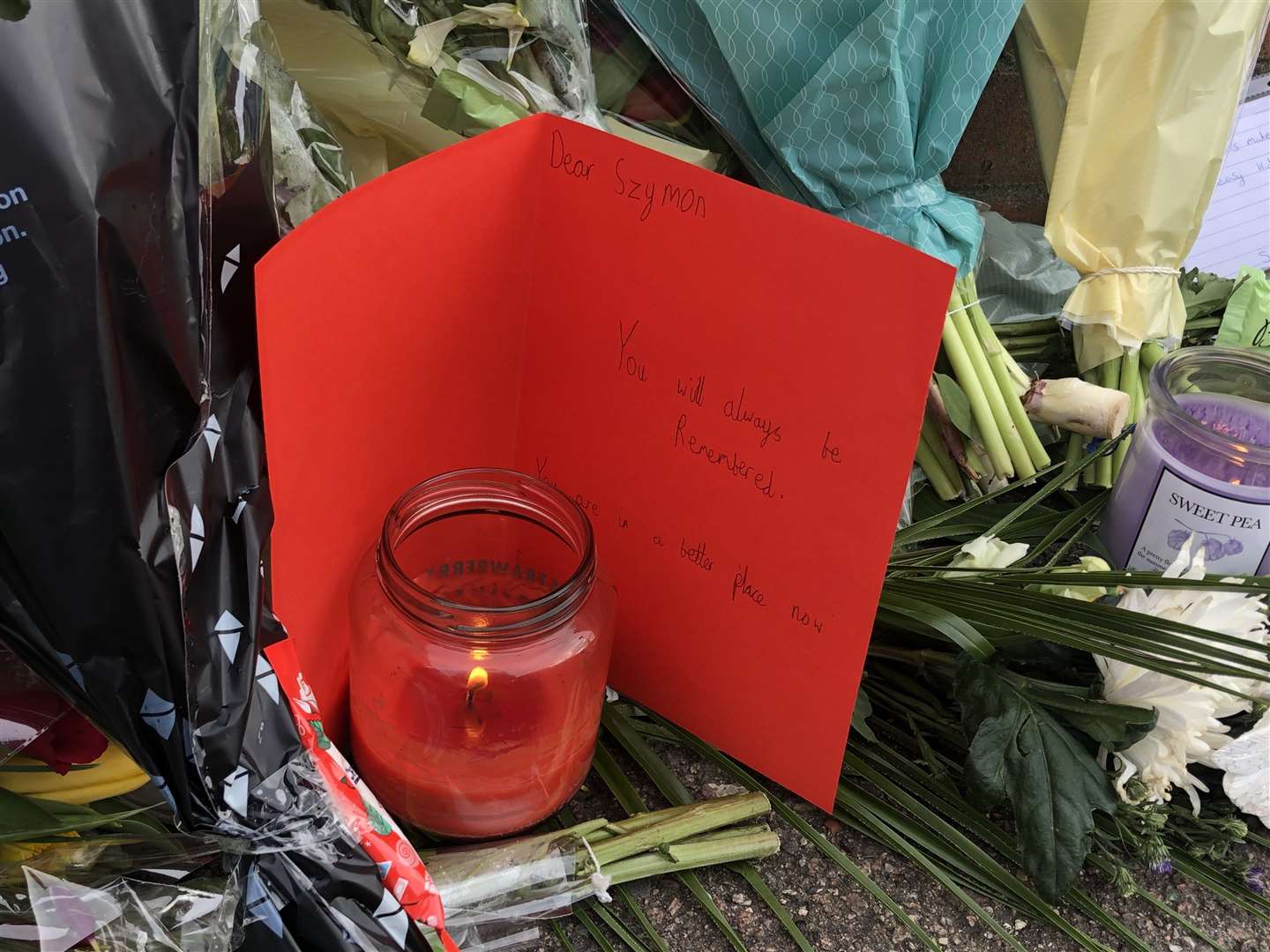 Floral, candle and basketball tributes have been laid in Vale Road