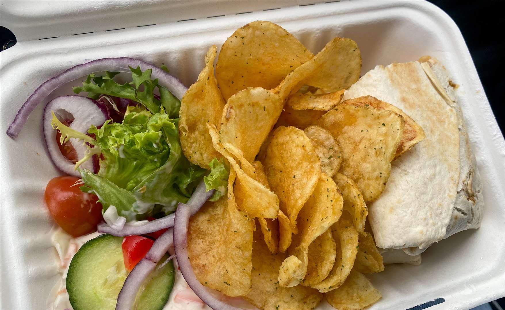 I opened my container to find crisps, a side salad and coleslaw alongside my burrito wrap. Picture: Sam Lawrie