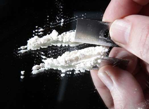 Stock image of cocaine being cut