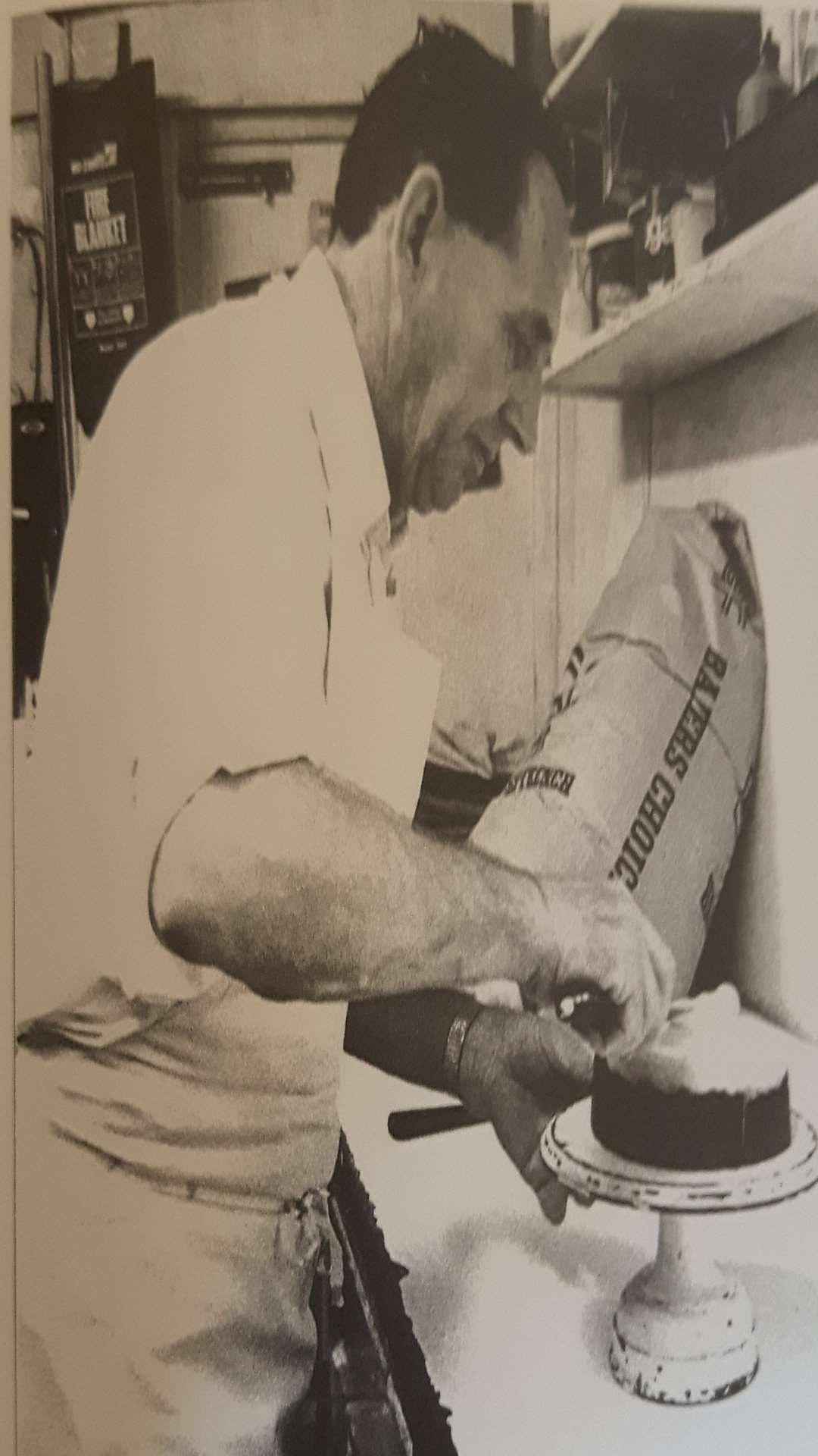 John Rogers at work decorating one of his many Christmas and wedding cakes