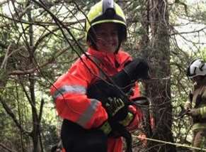 A firefighter with one of the rescued dogs