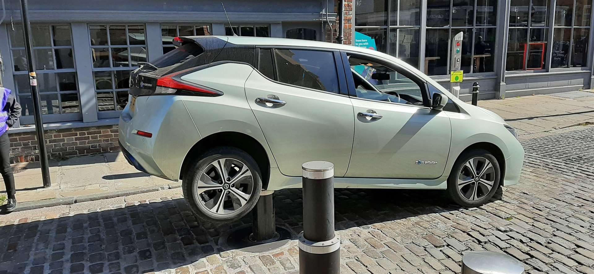 Oh dear! The Nissan Leaf trapped on top of Canterbury's expensive defence system. Pictures: Andrew Corby