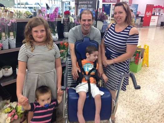 The family trying out the chair for the first time