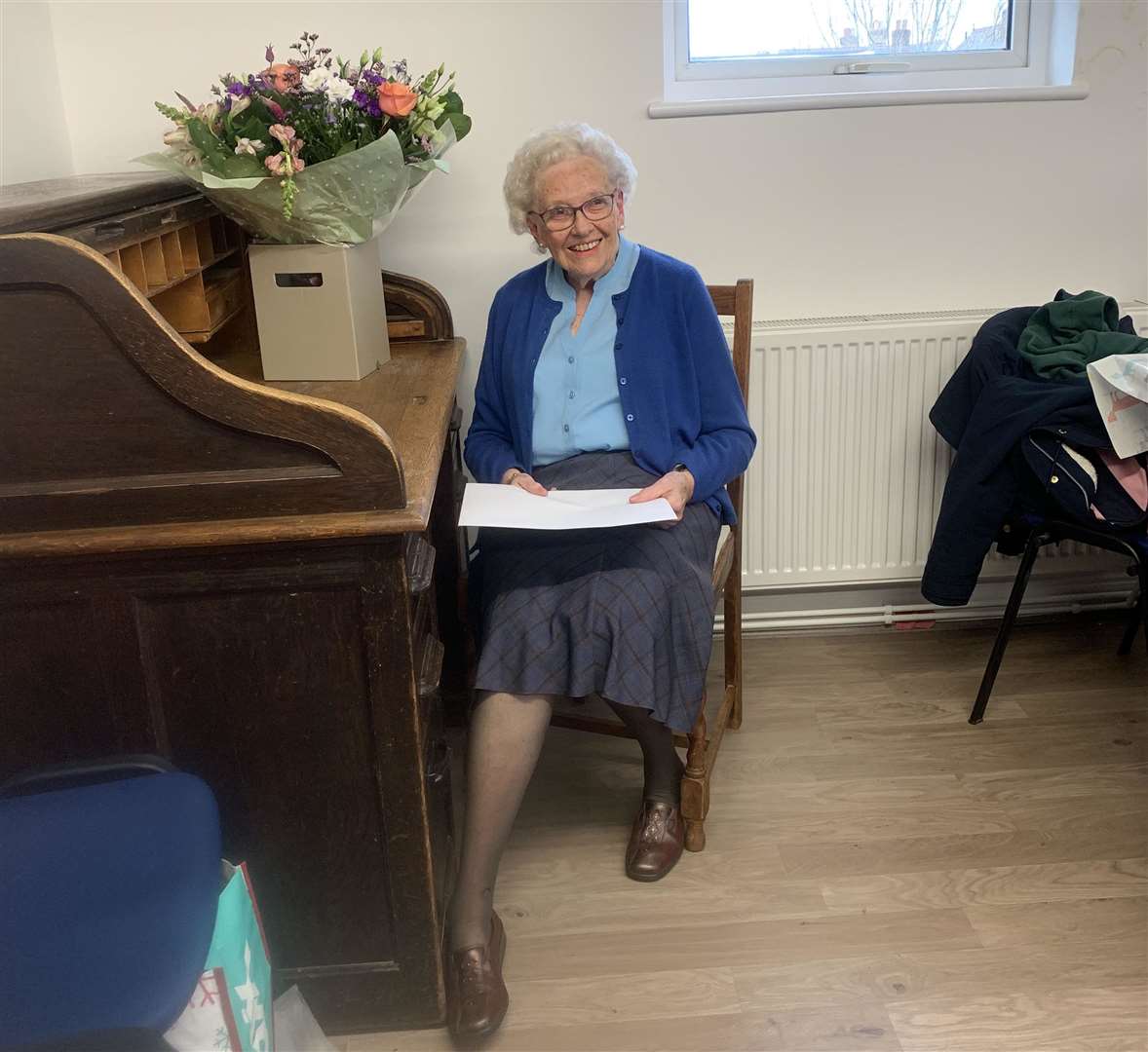 Muriel Taylor sitting at the desk where she first worked as a 15-year-old