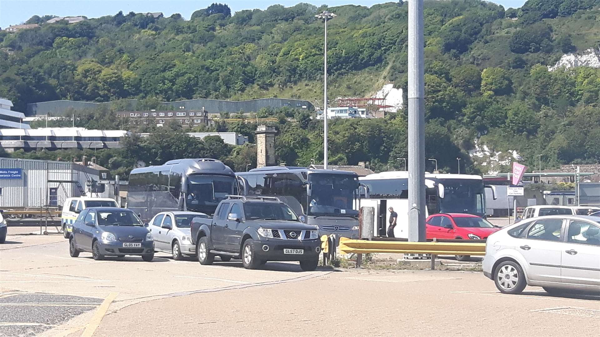 Coaches containing migrants brought ashore, are taken to an intake unit further inside Dove Docks for finger printing