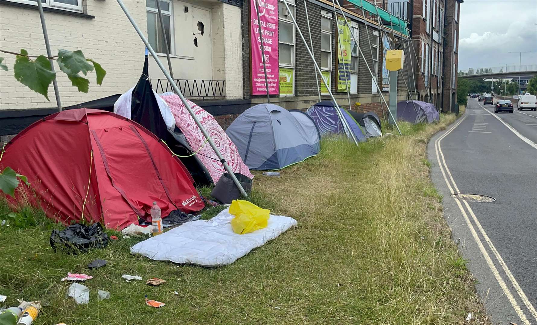 A homeless camp on the verge at the intersection of Pin Hill and Station Road East, Canterbury, right outside Catching Lives day centre