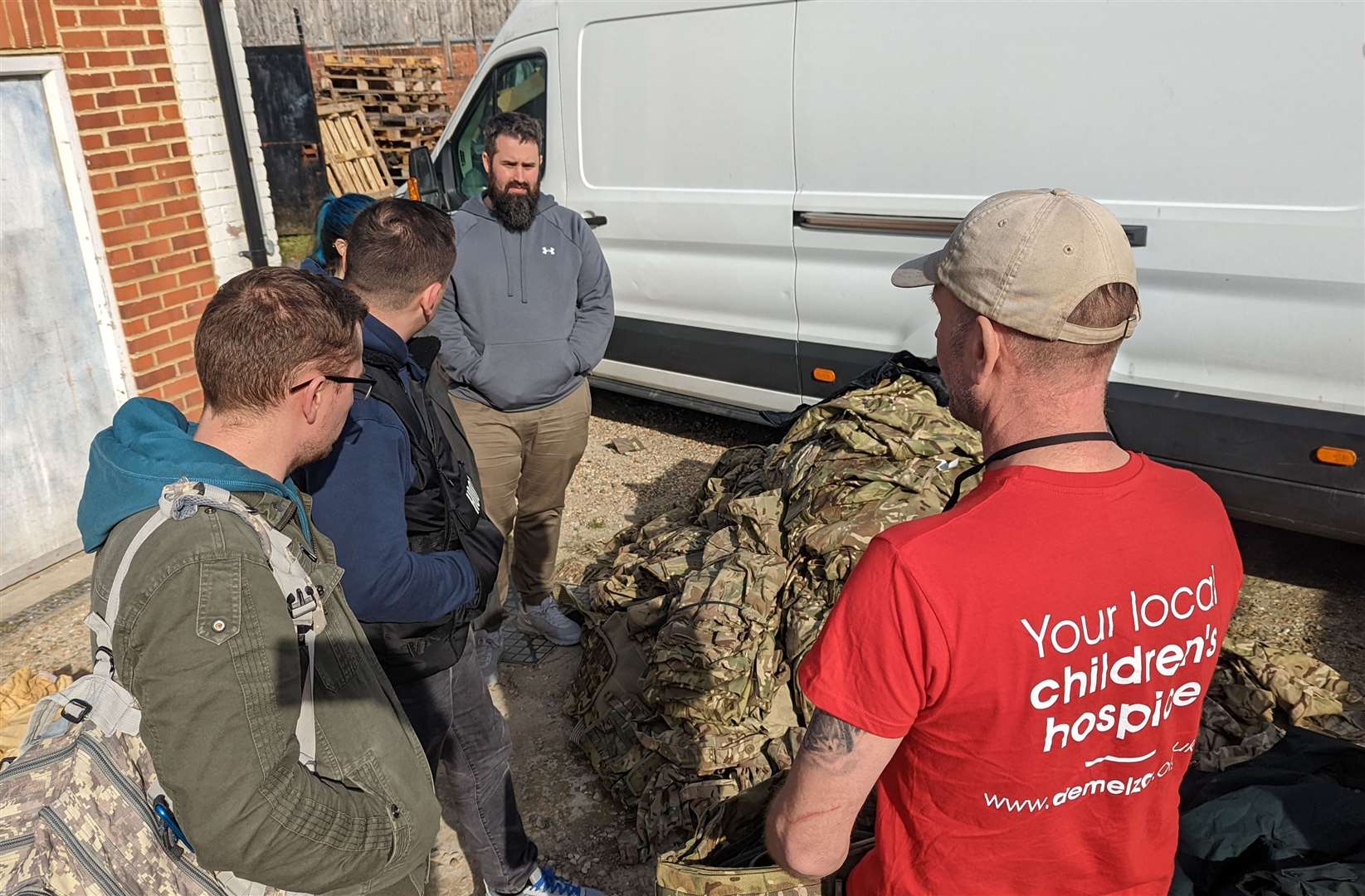 Wozza, right, speaks to the Ukrainians who have travelled to Folkestone