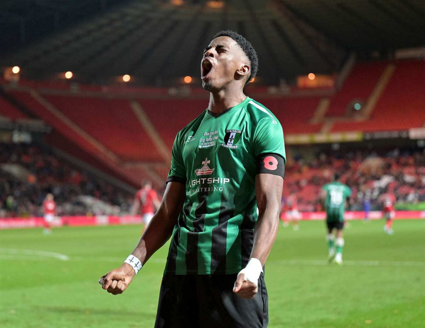 Kyrell Lisbie celebrates Cray Valley’s second-half equaliser in front of 2,000 away fans in the Jimmy Seed Stand. Picture: Keith Gillard