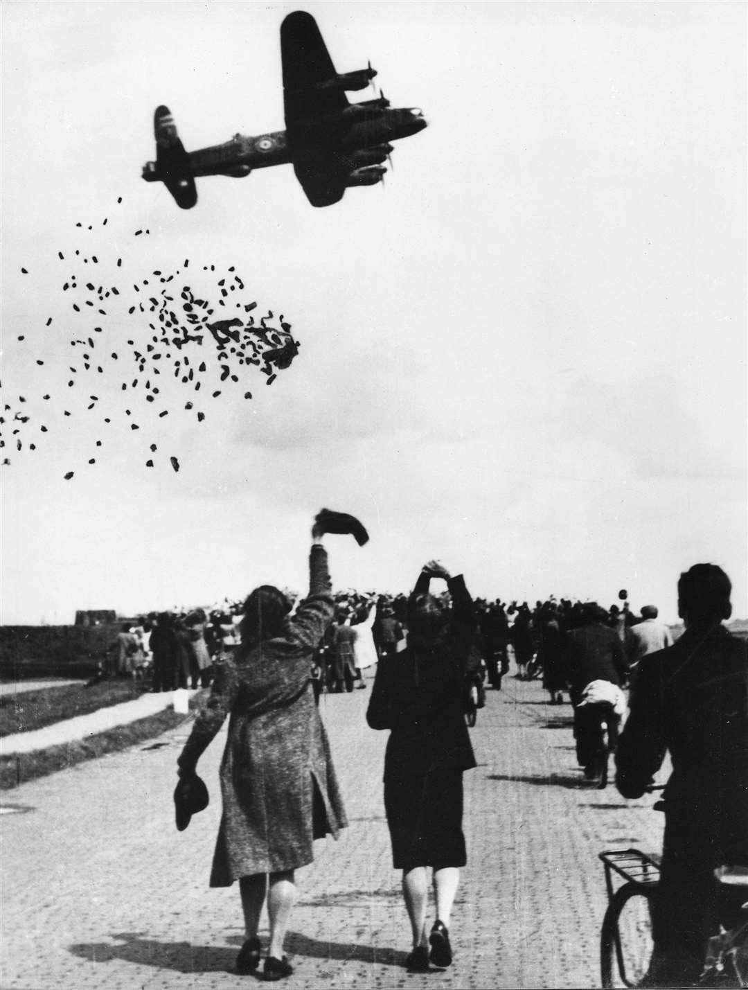 Crowds wave as RAF aircraft drop supplies from above (Crown/PA)