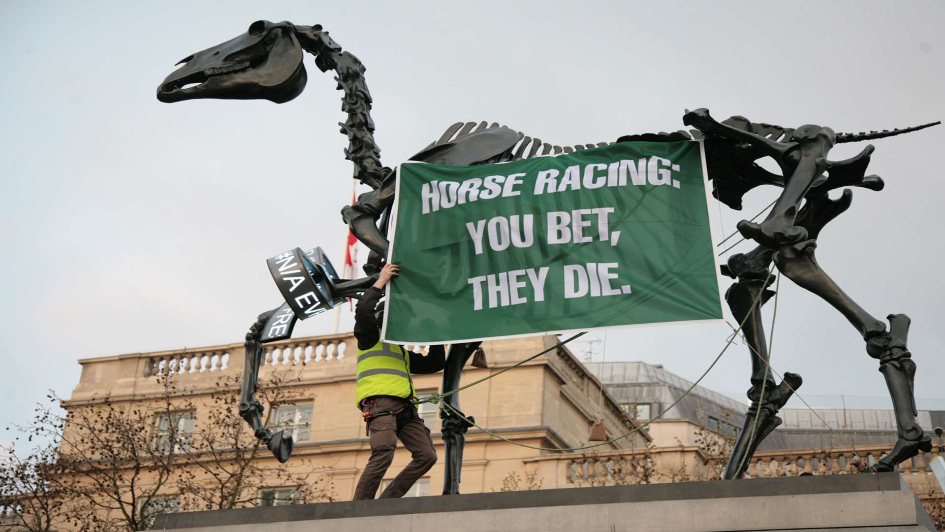 The protester placing the banner on the artwork