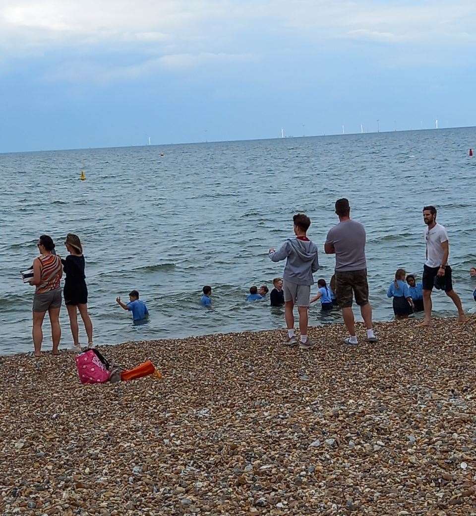 Some parents chose to let their children enjoy getting their uniforms wet while others decided to keep them on the shore. Picture: Wendy Hudson