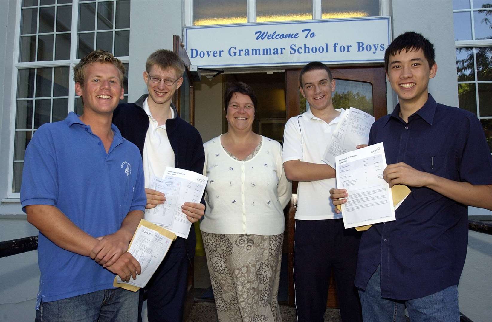 Former pupils at the Dover Grammar School for boys (left to right) Simon Bishop, Tom Munford, James Hutchinson and James Rowson celebrating with headteacher Mrs Sally Lees. Picture: Gerry Whittaker