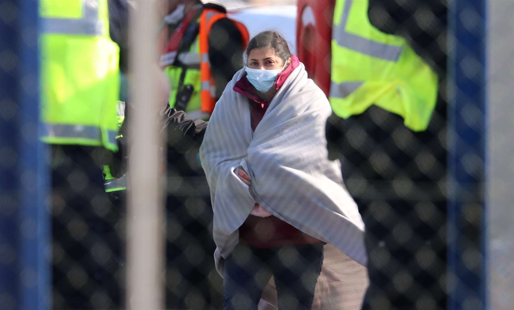 Border Force officers process a woman believed to be a migrant (Gareth Fuller/PA)