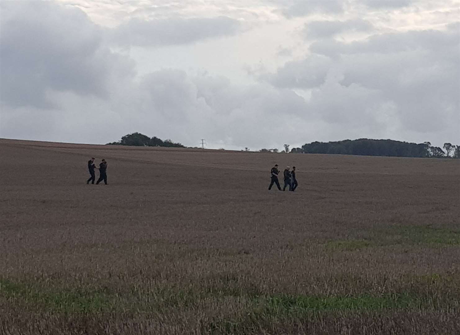 Officers were spotted in the field with the two men. Picture: Phil Ward