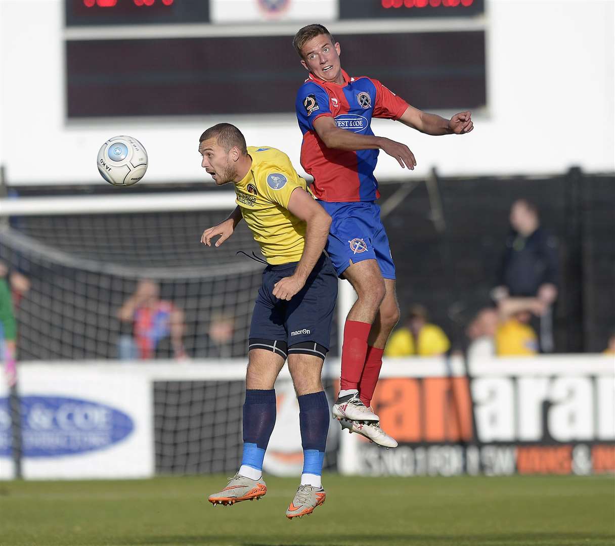 Michael Cheek up for a header with Will Wright Picture: Jimmy Griffiths