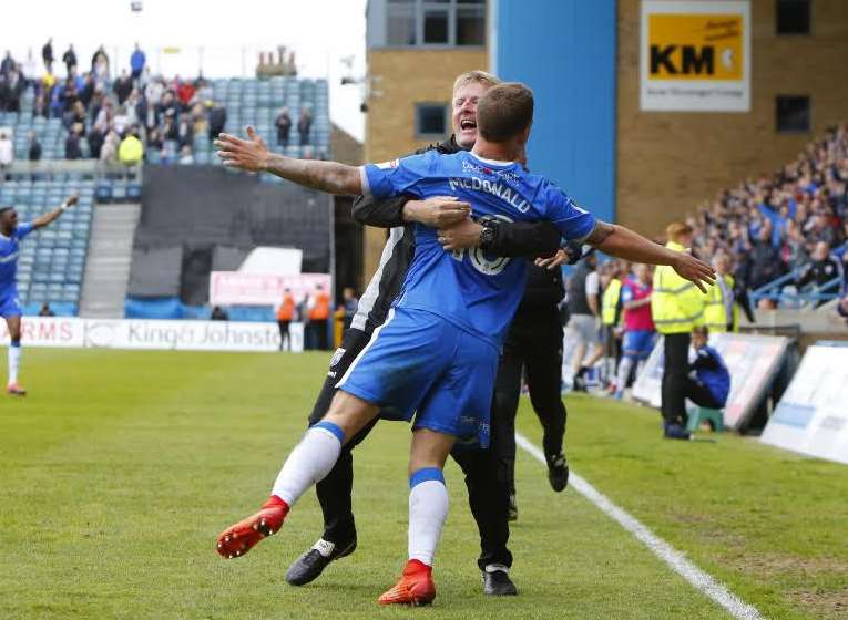 Gills boss Ady Pennock embraces goalscorer Cody McDonald last season Picture: Andy Jones