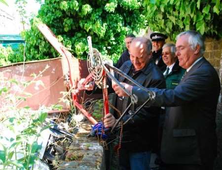 Police and council officers examine some of the rubbish found in an alleyway off Northdown Road, Cliftonville, during Operation Clean Sweep.