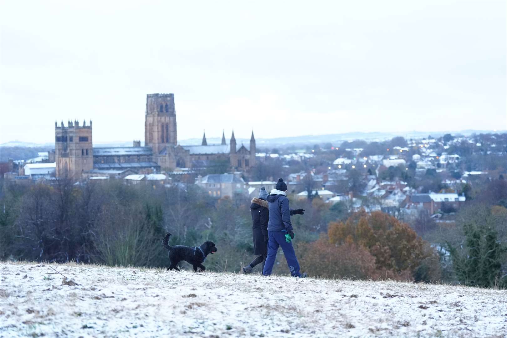 Early morning dog walkers near Durham Cathedral (Owen Humphreys/PA)