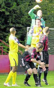 Chatham Town (red and black) pile on the pressure against Croydon Athletic.