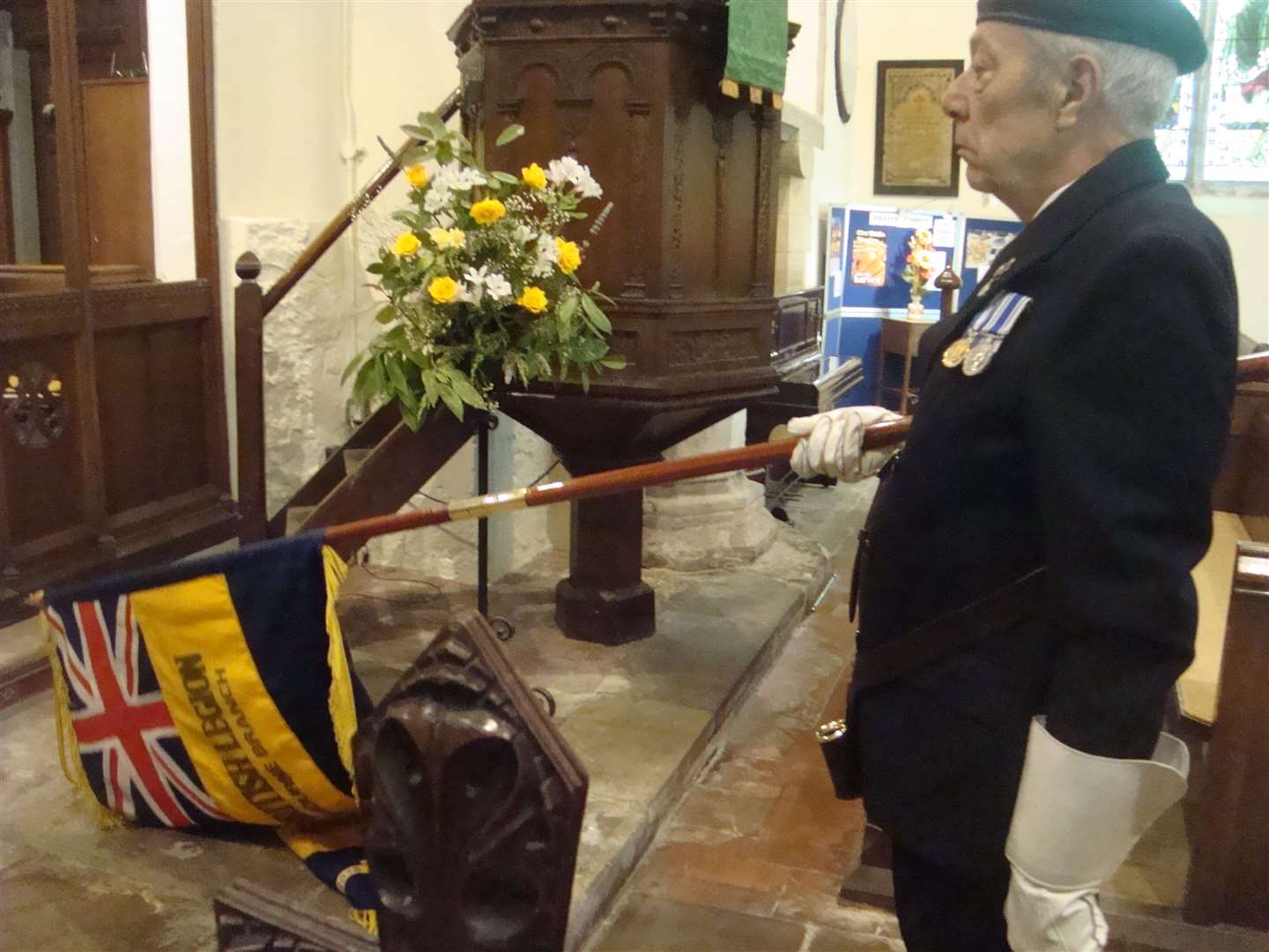 Geoff Lees, the County Parade Marshal, dips the standard to the Last Post