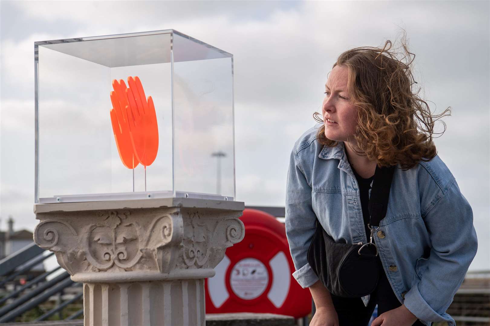 A work by Maureen Jordan on Folkestone sea front's Plinth is studied. Picture: Matt Crossick/PA Wire