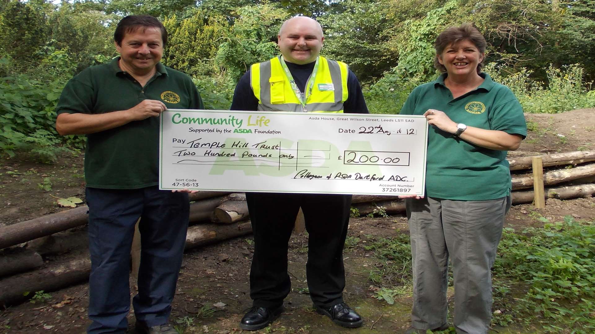 Asda donation to The Enchanted Woodland. Steve Taylor (volunteer Woodland Ranger), Stephen Reid (Asda General Manager) and Deborah Fryer (chief executive, Temple Hill Trust)