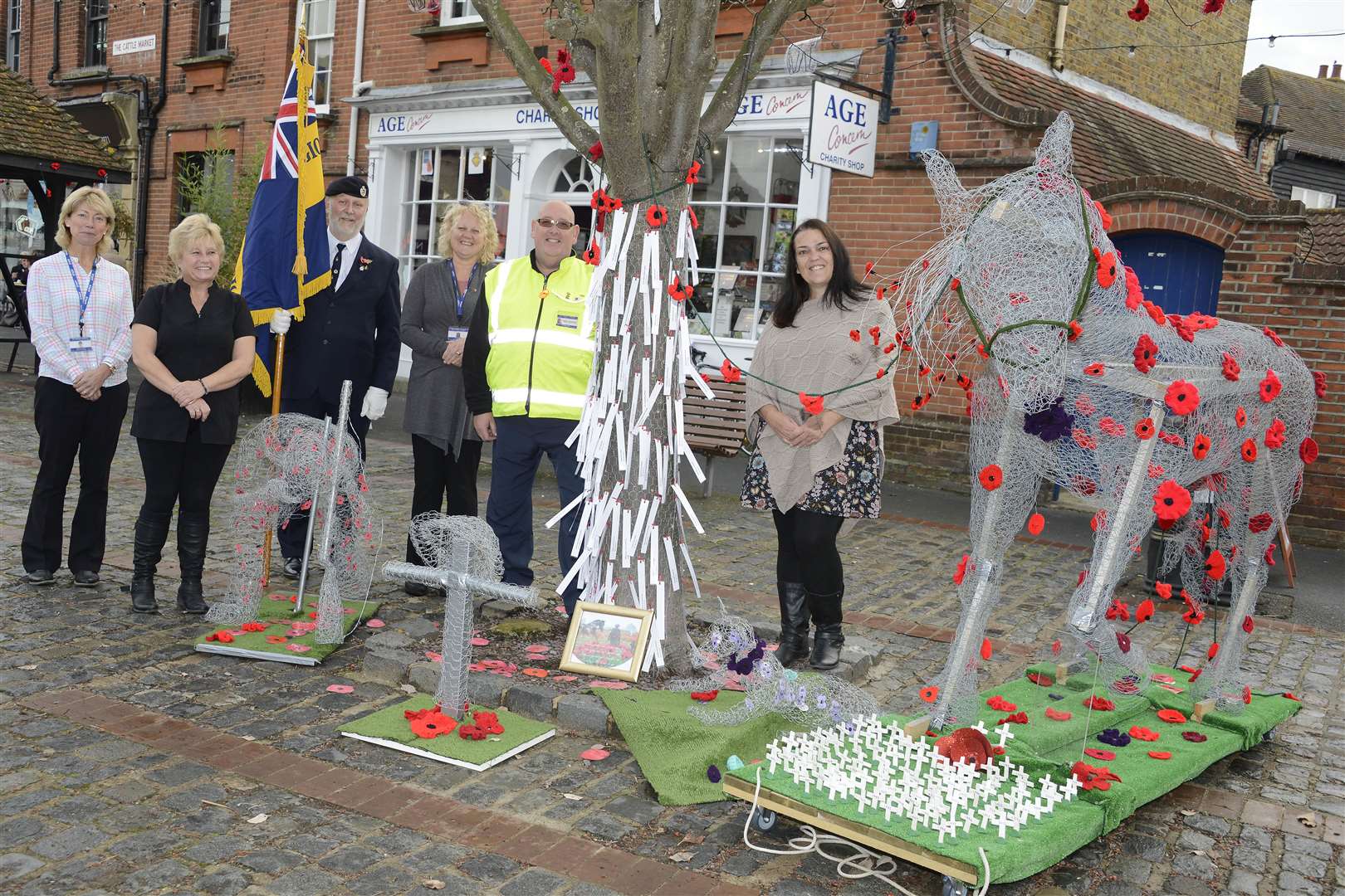 Volunteers from Age Concern and designer Sara Kardamitsis with the Remembrance display. Picture: Paul Amos