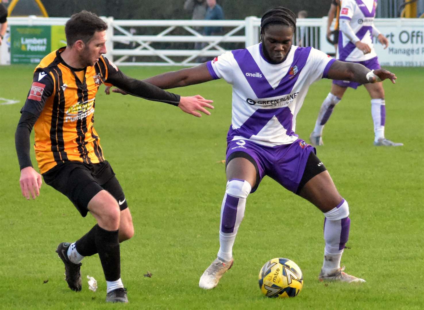 Folkestone's Ian Draycott closes in on a Brightlingsea player. Picture: Randolph File