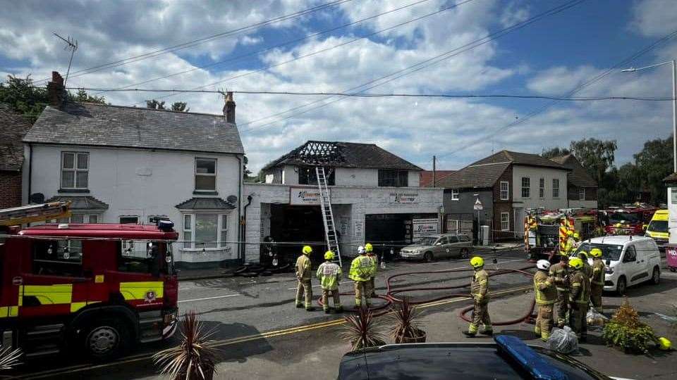 Firefighters during the aftermath of the Sturry Tyres blaze near Canterbury. Picture: Trisha Childs