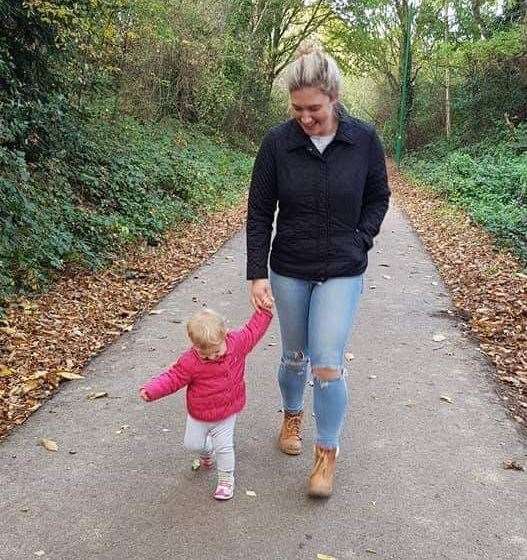 Hannah walks along the path with daughter Isabelle