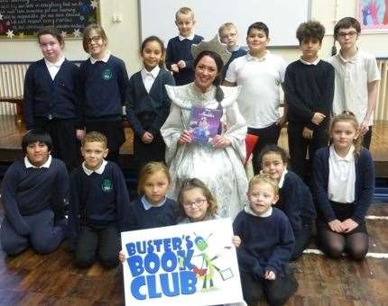 Georgia Rowland-Elliott in her Princess Jasmine costume with young readers at Parkside Community Primary School (23149450)