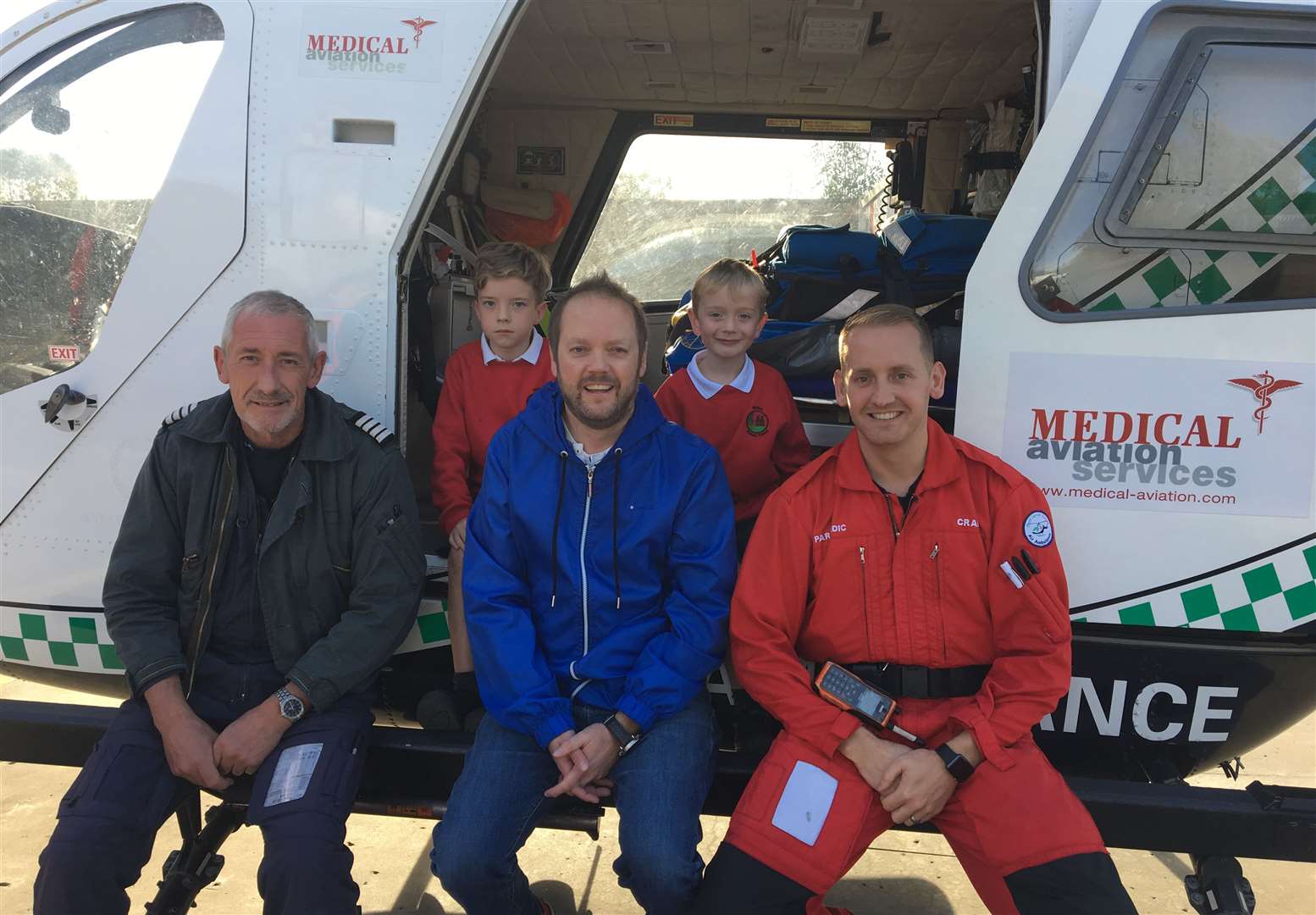 Crews treated Warren (centre) at the airbase before he was taken to hospital. Picture: KSS