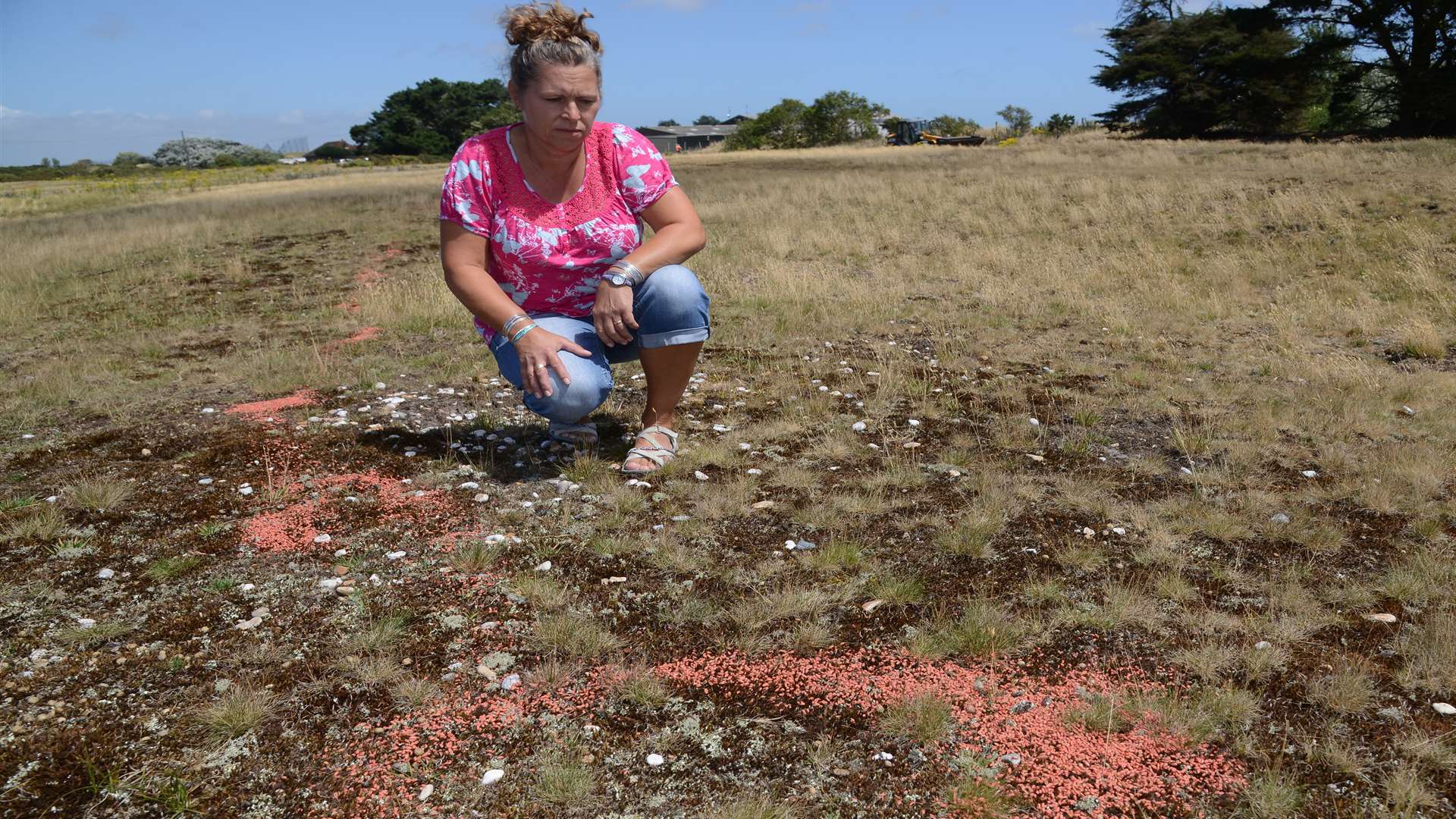 Jenny Coleman with the red-coloured seeds.