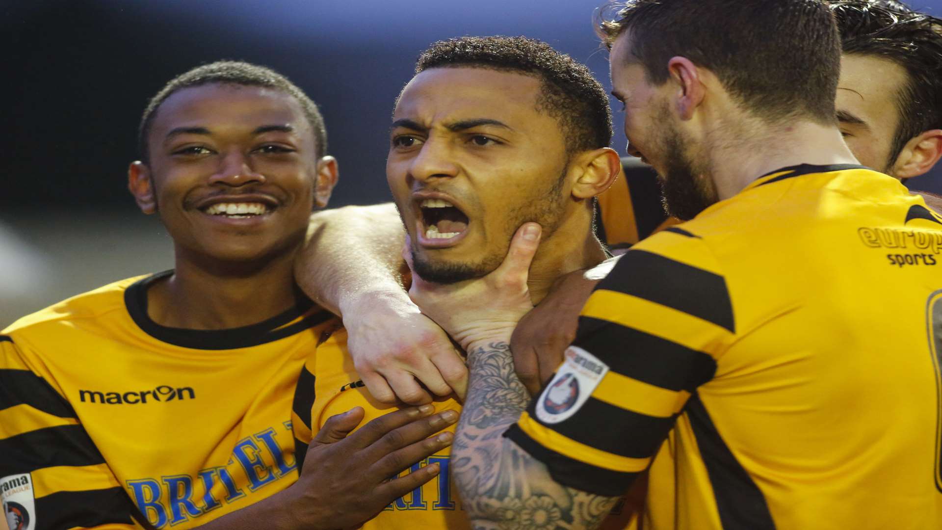 Vas Karagiannis, centre, celebrates his winner with Charles Banya, James Rogers and Tom Mills Picture: Martin Apps