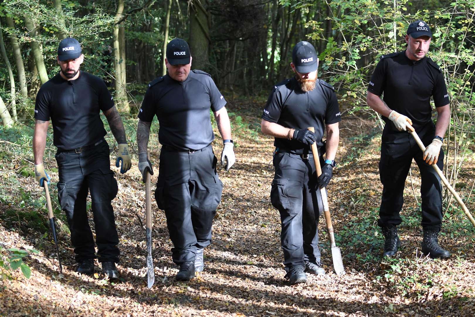 Officers combing woodland. Picture: Steve Finn