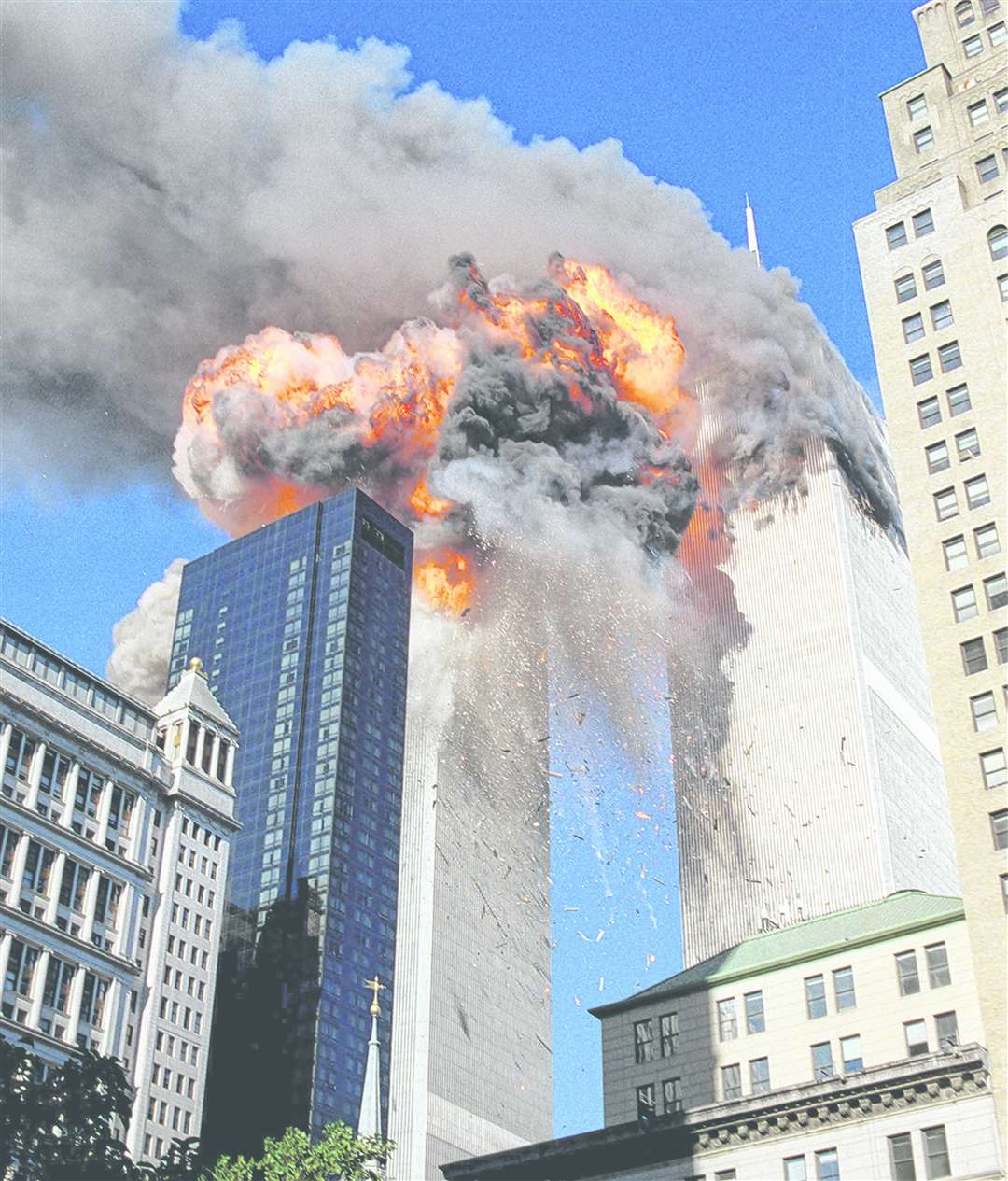 Smoke, flames and debris erupts from one of the World Trade Center towers as a plane strikes it on Tuesday, September 11, 2001. Picture: AP Photo/Chao Soi Cheong