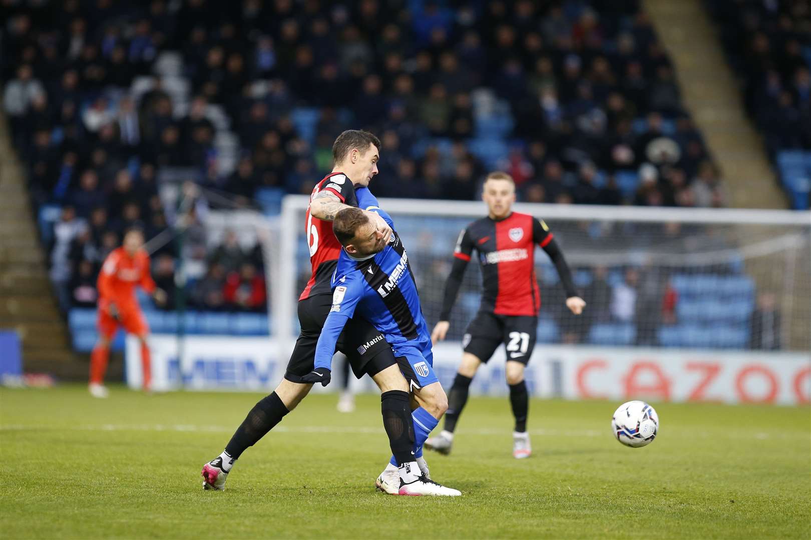 Shaun Williams up against Gillingham last season, in a battle with midfielder Danny Lloyd for the ball Picture: Andy Jones