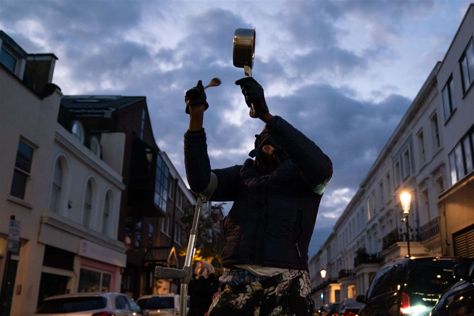 One member of the public bangs a pot to add to the tribute (Aaron Chown/PA)